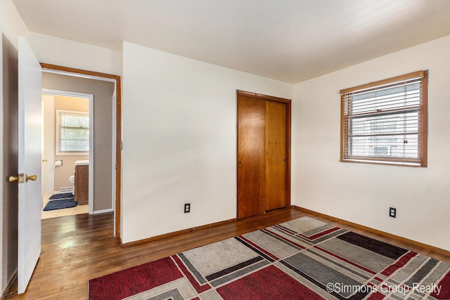 252 Jeffrey St, Cedar Springs, MI 49319 - unfurnished bedroom with wood finished floors and a closet