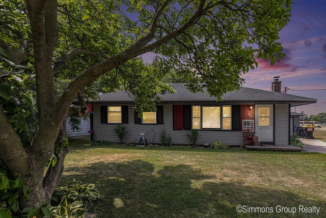 252 Jeffrey St, Cedar Springs, MI 49319 - view of front of home featuring a front lawn, a shingled roof, and a chimney