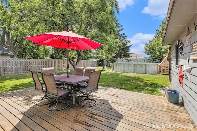 252 Jeffrey St, Cedar Springs, MI 49319 - wooden terrace with outdoor dining area and a fenced backyard