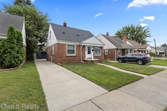 22951 Audette, Dearborn, MI 48124 - view of front of house with brick siding, a front yard, concrete driveway, an outdoor structure, and a chimney