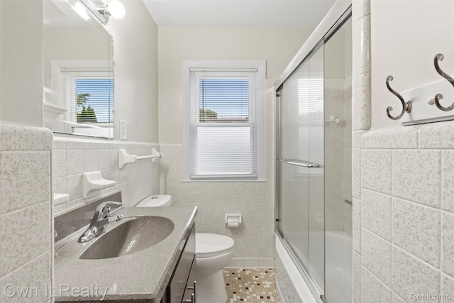 22951 Audette, Dearborn, MI 48124 - bathroom with tile walls, tile patterned flooring, vanity, plenty of natural light, and enclosed tub / shower combo