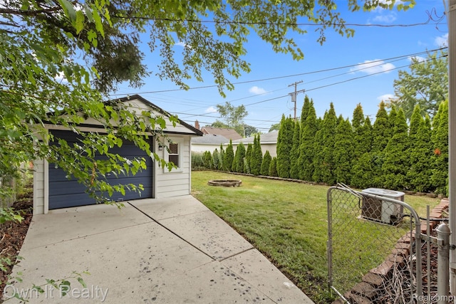 22951 Audette, Dearborn, MI 48124 - view of green lawn with an outdoor fire pit, an outdoor structure, and a garage