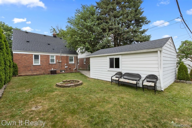 22951 Audette, Dearborn, MI 48124 - rear view of property featuring a yard, a fire pit, roof with shingles, and brick siding