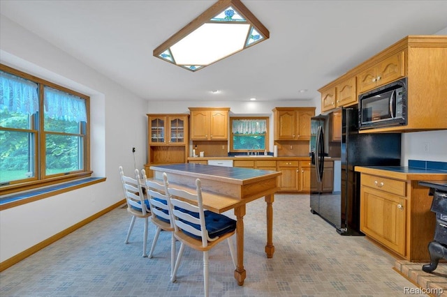 1829 Farnsworth Rd, Lapeer, MI 48446 - kitchen with black appliances, glass insert cabinets, and recessed lighting