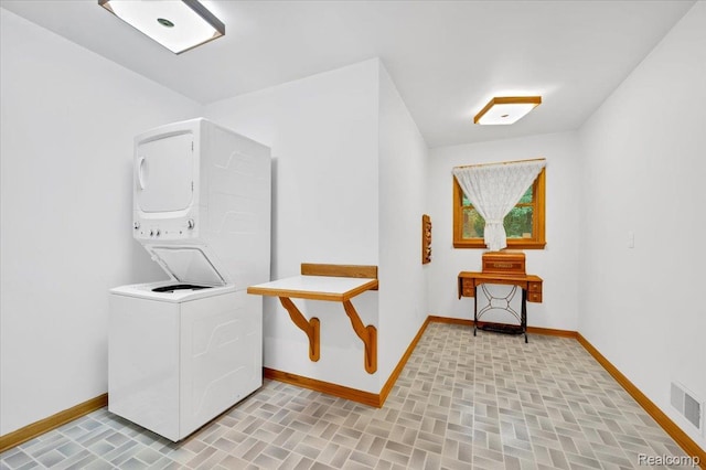 1829 Farnsworth Rd, Lapeer, MI 48446 - laundry room featuring stacked washer / drying machine and brick patterned flooring