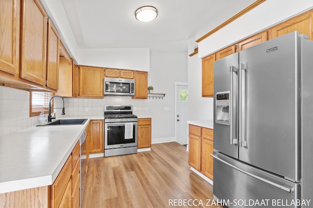 3520 Auburn Ave NE, Grand Rapids, MI 49525 - kitchen with appliances with stainless steel finishes, tasteful backsplash, light wood-type flooring, and light countertops