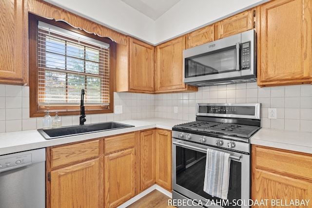 3520 Auburn Ave NE, Grand Rapids, MI 49525 - kitchen with appliances with stainless steel finishes, light countertops, backsplash, and light wood-style flooring
