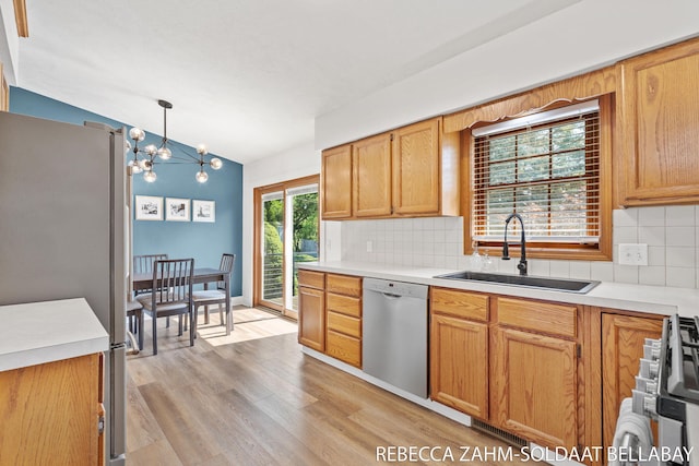 3520 Auburn Ave NE, Grand Rapids, MI 49525 - kitchen featuring dishwasher, freestanding refrigerator, vaulted ceiling, decorative backsplash, and light wood-type flooring