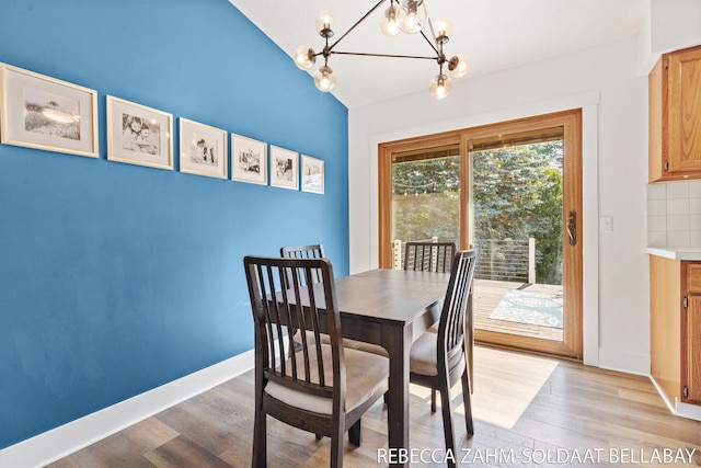 3520 Auburn Ave NE, Grand Rapids, MI 49525 - dining space featuring light wood-style flooring, a chandelier, and lofted ceiling