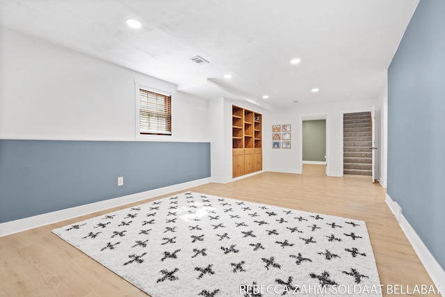 3520 Auburn Ave NE, Grand Rapids, MI 49525 - empty room with light wood-type flooring, stairs, recessed lighting, and built in shelves
