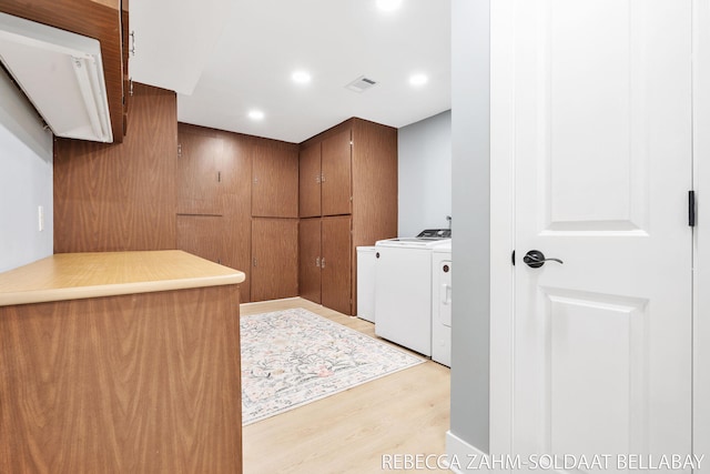 3520 Auburn Ave NE, Grand Rapids, MI 49525 - laundry area with washer and dryer, light wood finished floors, recessed lighting, and cabinet space
