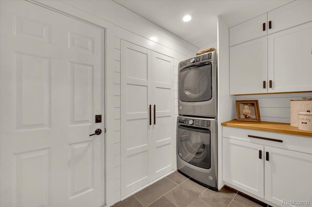 5612 Northcrest Xing, Clarkston, MI 48346 - laundry room with estacked washer and dryer, cabinet space, tile patterned flooring, and recessed lighting
