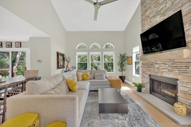 5612 Northcrest Xing, Clarkston, MI 48346 - living area with high vaulted ceiling, a fireplace, wood finished floors, and a ceiling fan