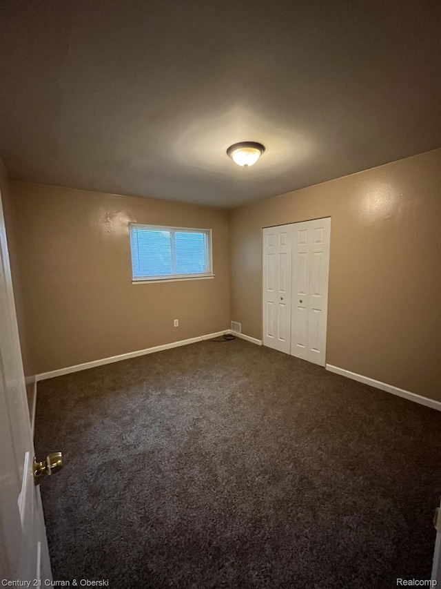6179 Sylvia St, Taylor, MI 48180 - unfurnished bedroom with dark colored carpet