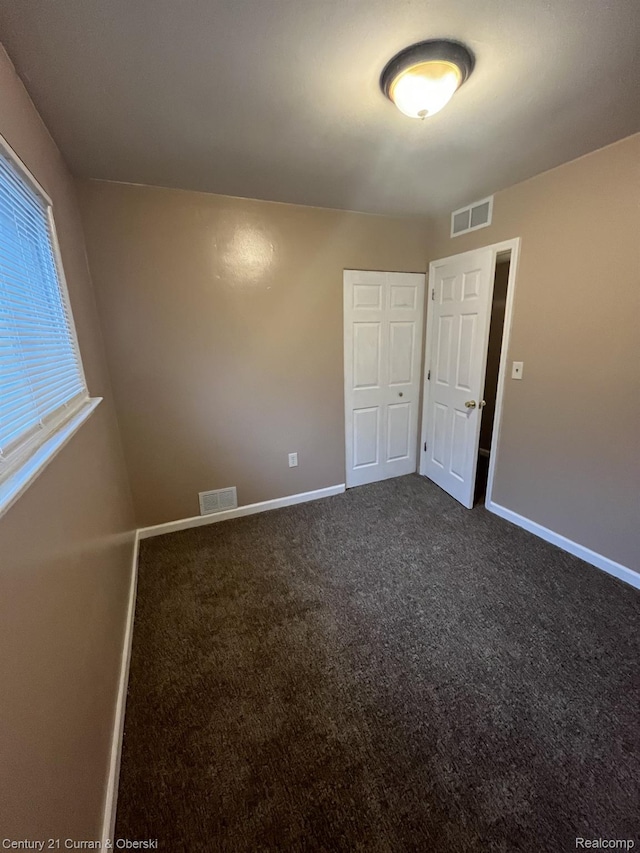 6179 Sylvia St, Taylor, MI 48180 - spare room featuring baseboards and dark carpet