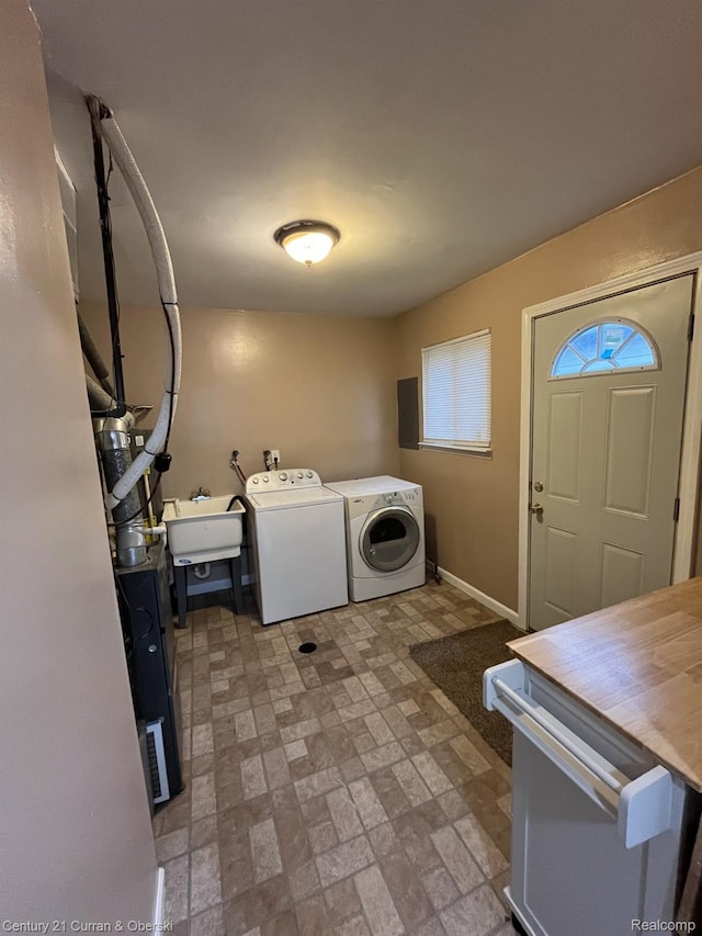 6179 Sylvia St, Taylor, MI 48180 - washroom featuring separate washer and dryer and brick patterned floors