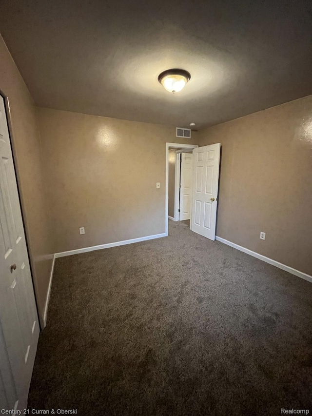 6179 Sylvia St, Taylor, MI 48180 - unfurnished bedroom featuring dark carpet and a closet