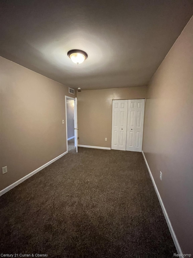 6179 Sylvia St, Taylor, MI 48180 - unfurnished bedroom with dark carpet and a closet