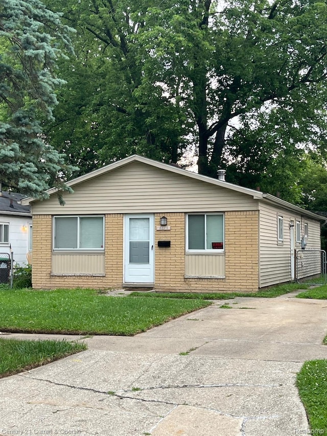 6179 Sylvia St, Taylor, MI 48180 - view of front facade featuring brick siding and a front lawn