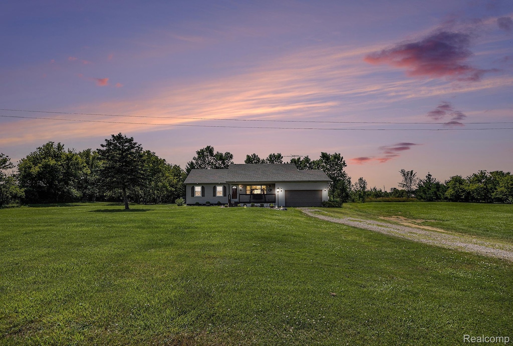 2866 Graham Rd, Imlay City, MI 48444 - ranch-style house with driveway, a garage, and a front yard
