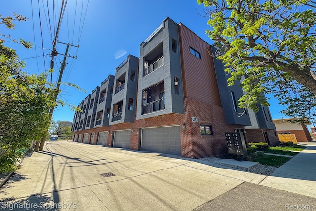 2037 11th St Unit 3, Detroit, MI 48216 - view of building exterior with a garage and driveway