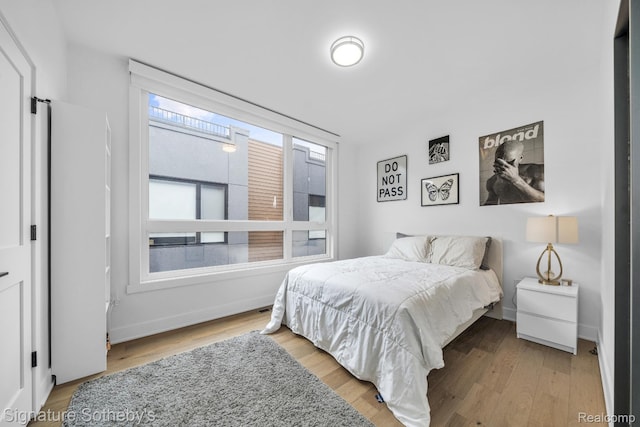 2037 11th St Unit 3, Detroit, MI 48216 - bedroom with wood finished floors and baseboards