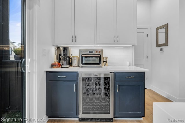 2037 11th St Unit 3, Detroit, MI 48216 - bar with beverage cooler, light wood-style floors, and tasteful backsplash
