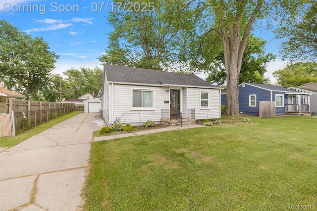 5869 Marvin St, Taylor, MI 48180 - bungalow featuring roof with shingles, a garage, and an outbuilding