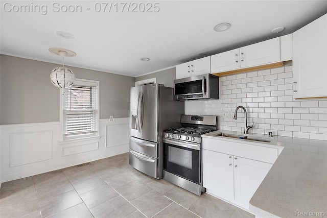 5869 Marvin St, Taylor, MI 48180 - kitchen with appliances with stainless steel finishes, white cabinets, decorative light fixtures, crown molding, and a chandelier