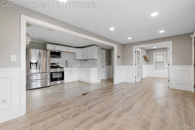 5869 Marvin St, Taylor, MI 48180 - kitchen featuring stainless steel appliances, light countertops, wainscoting, white cabinets, and recessed lighting