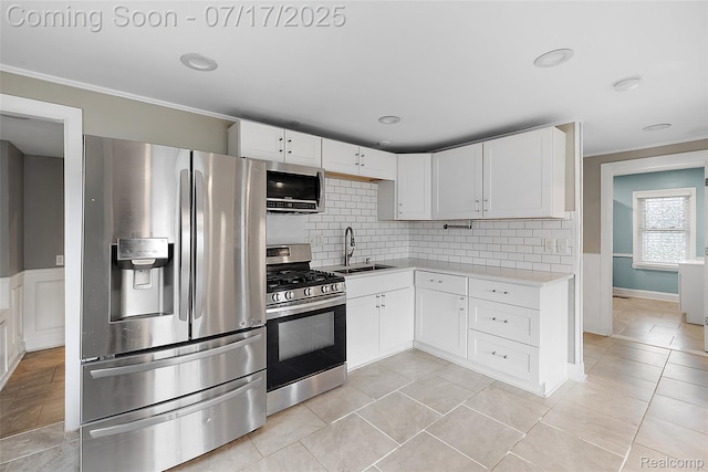 5869 Marvin St, Taylor, MI 48180 - kitchen with stainless steel appliances, light countertops, backsplash, ornamental molding, and white cabinets