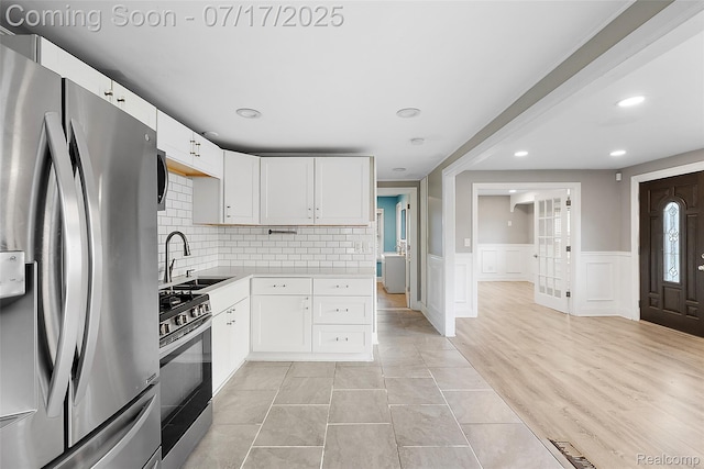 5869 Marvin St, Taylor, MI 48180 - kitchen with appliances with stainless steel finishes, light countertops, white cabinetry, tasteful backsplash, and recessed lighting