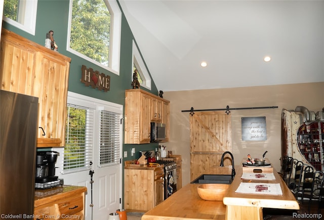 2223 Hidden Valley Rd, Howell, MI 48843 - kitchen with stainless steel appliances, high vaulted ceiling, recessed lighting, and a barn door