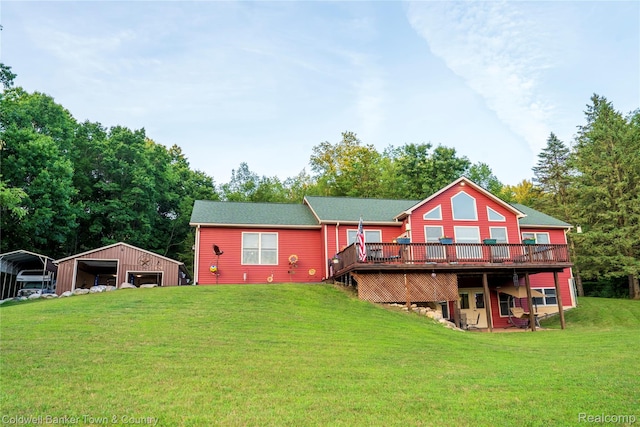 2223 Hidden Valley Rd, Howell, MI 48843 - back of property featuring a wooden deck, a yard, an outbuilding, a detached carport, and a garage