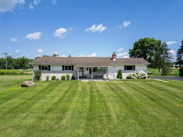 1140 Wing Dr, Ann Arbor, MI 48103 - rear view of house featuring a chimney, a lawn, and a porch