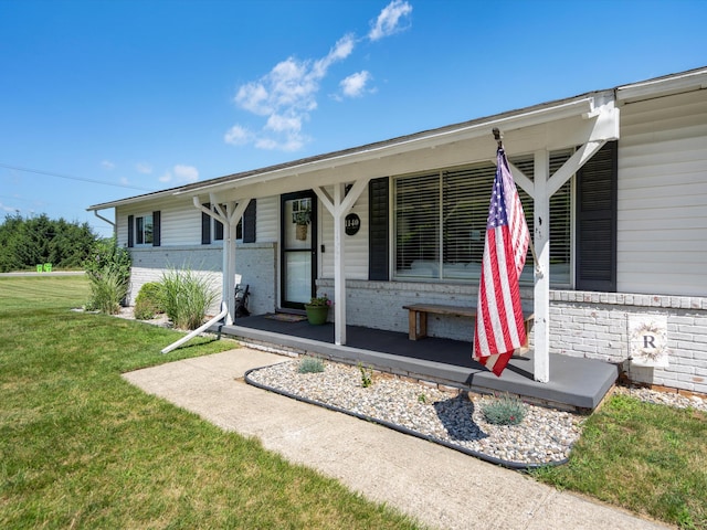 1140 Wing Dr, Ann Arbor, MI 48103 - view of front facade featuring covered porch, a front yard, and brick siding