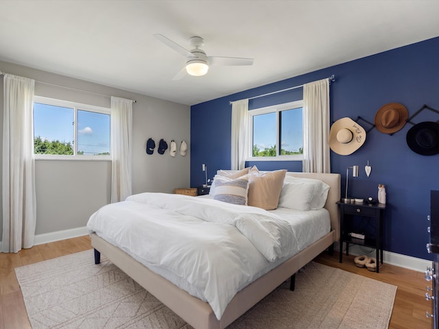 1140 Wing Dr, Ann Arbor, MI 48103 - bedroom featuring multiple windows, light wood finished floors, and a ceiling fan