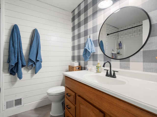 1140 Wing Dr, Ann Arbor, MI 48103 - bathroom featuring vanity, wallpapered walls, and wood finished floors
