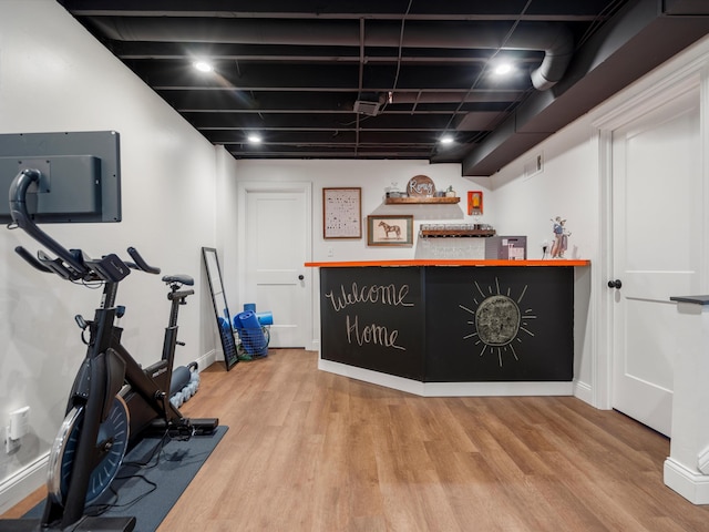1140 Wing Dr, Ann Arbor, MI 48103 - workout room with light wood-type flooring and a dry bar