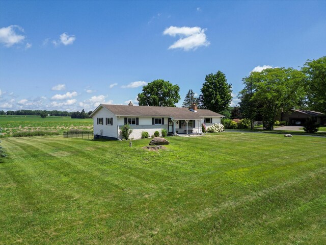 1140 Wing Dr, Ann Arbor, MI 48103 - rear view of property with a lawn and a chimney