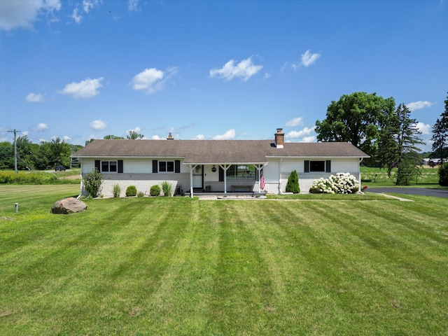 1140 Wing Dr, Ann Arbor, MI 48103 - rear view of house featuring a chimney, a lawn, and a porch