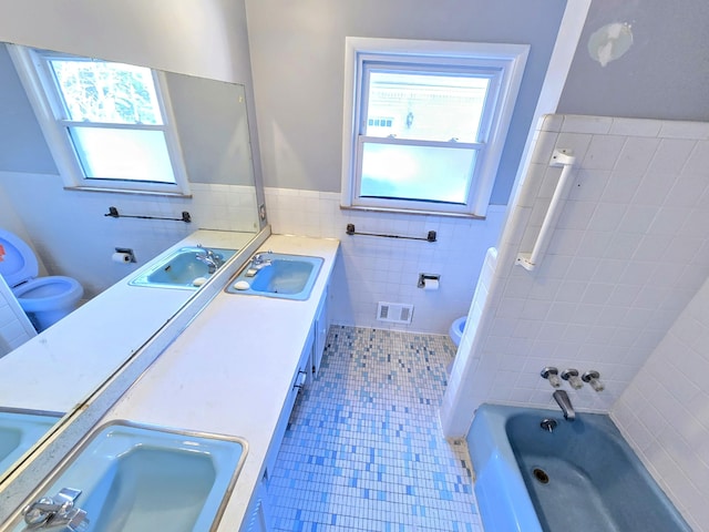 27751 Palomino Ave, Warren, MI 48093 - bathroom featuring tile walls, double vanity, a wainscoted wall, and tile patterned floors