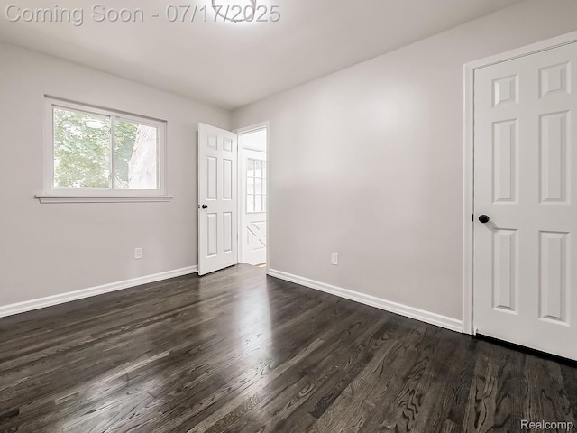 2314 Middlebelt Rd, West Bloomfield, MI 48324 - unfurnished bedroom with baseboards and dark wood-style floors