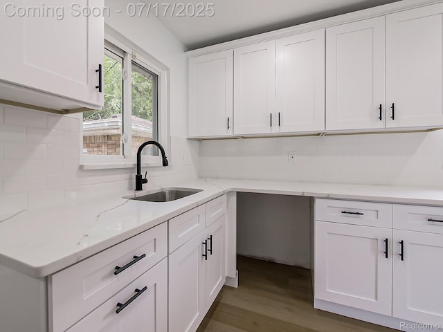 2314 Middlebelt Rd, West Bloomfield, MI 48324 - kitchen with wood finished floors, white cabinets, tasteful backsplash, and light stone countertops