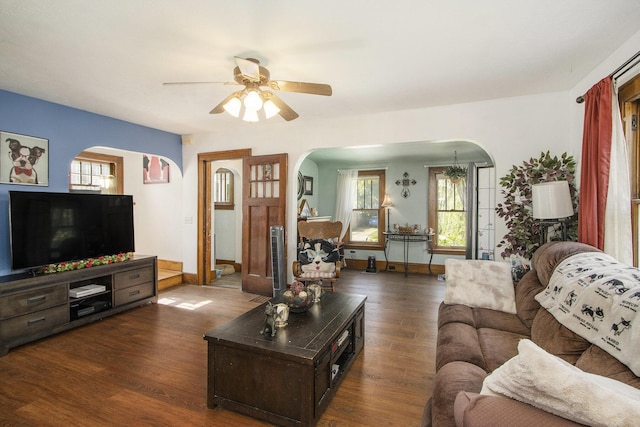 2136 Amherst Ave, Kalamazoo, MI 49008 - living room with arched walkways, a ceiling fan, dark wood finished floors, and plenty of natural light