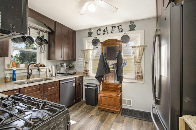 2136 Amherst Ave, Kalamazoo, MI 49008 - kitchen with appliances with stainless steel finishes, a ceiling fan, dark wood-style floors, light countertops, and dark brown cabinetry