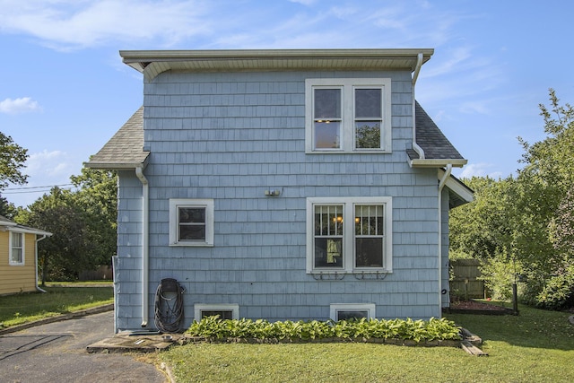 2136 Amherst Ave, Kalamazoo, MI 49008 - view of side of home with roof with shingles and a yard