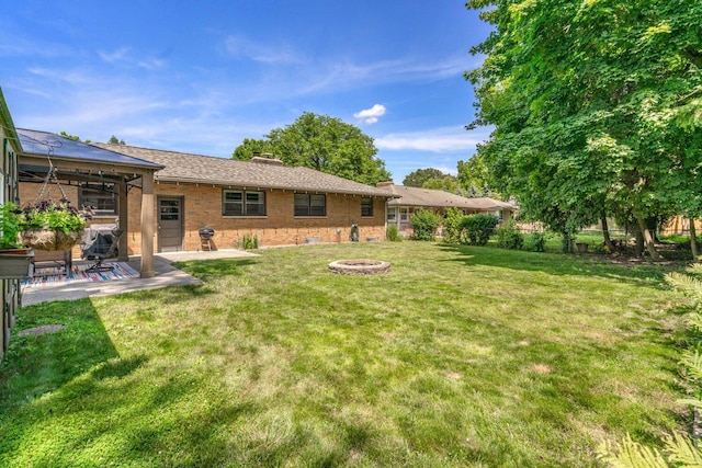 923 Par 4 Rd, Kalamazoo, MI 49008 - view of green lawn with a patio and a fire pit
