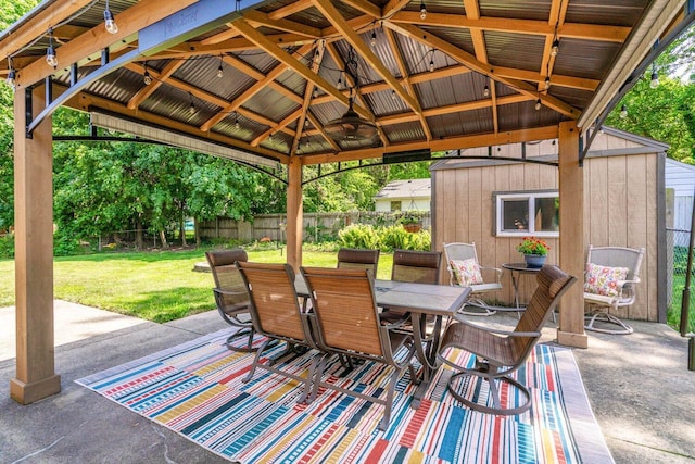 923 Par 4 Rd, Kalamazoo, MI 49008 - fenced backyard featuring a storage unit, outdoor dining area, a patio area, and a gazebo