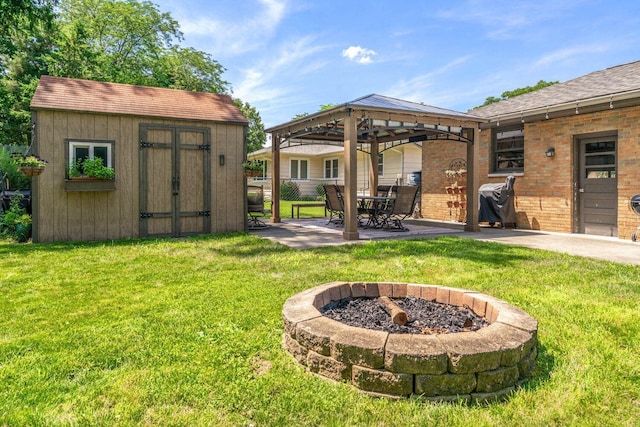 923 Par 4 Rd, Kalamazoo, MI 49008 - view of green lawn with an outdoor fire pit, a patio, a gazebo, and a storage shed